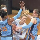  ?? AP ?? Marquette's Camryn Taylor and Lauren Van Kleunen try to stop Hokies star Elizabeth Kitley during their NCAA Tournament game Sunday. Kitley had 23 points and eight rebounds.