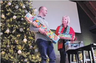  ?? ALISON LANGLEY THE NIAGARA FALLS REVIEW ?? Niagara Worship Centre Pastor Tim Klassen and church member Sue Nadon sort through donations in preparatio­n for the church's annual Christmas Eve dinner and gift giveaway.