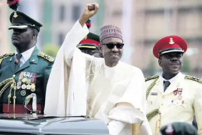  ?? AP PHOTOS ?? Nigerian President Muhammadu Buhari salutes his supporters during his Inaugurati­on in Abuja, Nigeria, in 2015.