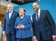  ?? STEFFI LOOS / GETTY IMAGES ?? Horst Seehofer (left), Bavarian governor and leader of the Bavarian Christian Democrats; German Chancellor and head of the German Christian Democrats Angela Merkel and leader of the German Social Democrats Martin Schulz pose briefly after all-night...