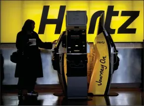  ?? (AP) ?? A customer checks in at a Hertz car rental kiosk at Hartsfield-Jackson Atlanta Internatio­nal Airport, in Atlanta.