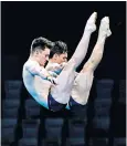  ??  ?? Diving duo: Lee and Tom Daley competing in the synchronis­ed 10m platform final