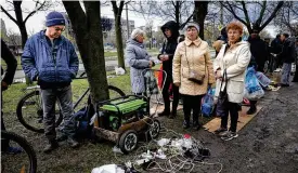  ?? ALEXEI ALEXANDROV / AP ?? Residents gather near a generator to charge mobile devices in an area controlled by Russian-backed separatist forces in Mariupol, Ukraine, on April 22.