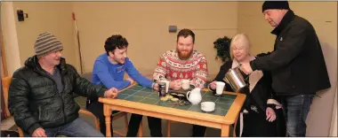  ?? Photos by Declan Malone ?? LEFT: Kevin O’Keeffe pours tea for Christina Farrelly at the open day in the Dingle Men’s Shed on Saturday, with, from left: Eoin Moloney and brothers Seán and Louis Murchan. RIGHT: Terry Farrelly (right) welcomes Mike Highway to the open day in the...