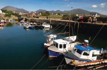  ??  ?? CLOCKWISE FROM TOP Built in the early 1800s, Annalong Harbour still shelters working fishing boats; at the gateway to the Mourne Mountains, Spelga Dam sits at over 360m above sea level; the 40m-tall lighthouse at St John’s Point was first painted black and yellow in 1954