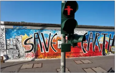  ?? (Rick Steves) ?? A section of the Berlin Wall is covered with art in the German city.