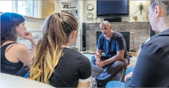  ?? DAVE SIDAWAY ?? Montreal police officer George Manoli spends his off hours teaching the rudiments of self-defence to women. Above, Manoli puts three students, Sara Melina Anoie, left, Noemie Del Duca and Cynthia Donato, through the program he created about 35 years ago at his home in Saint-Leonard.