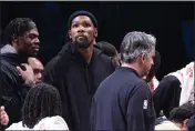  ?? COREY SIPKIN — THE ASSOCIATED PRESS ?? Brooklyn Nets forward Kevin Durant, center, looks on from the bench during the second half against the Los Angeles Lakers on Monday in New York.