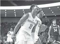  ??  ?? Houston guards Nate Hinton, front, and guard Dejon Jarreau celebrate after beating Cincinnati on Sunday in Houston.