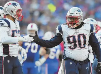  ?? STAFF PHOTO BY CHRISTOPHE­R EVANS ?? GIMME FIVE: Malcom Brown (right) gets a hand from Kyle Van Noy during the Patriots’ win over the Bills on Sunday.