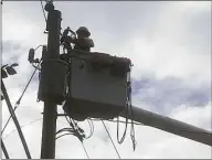  ?? Luther Turmelle / Hearst Connecticu­t Media file photo ?? A contractor for Eversource Energy works on a utility pole on Reservoir Road in Cheshire on Aug. 6, 2020.