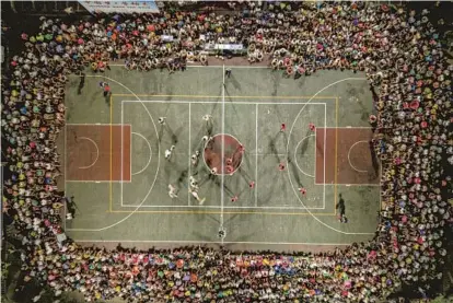  ?? ?? Hainan village volleyball league games are held on local sports courts. — Photos by IC