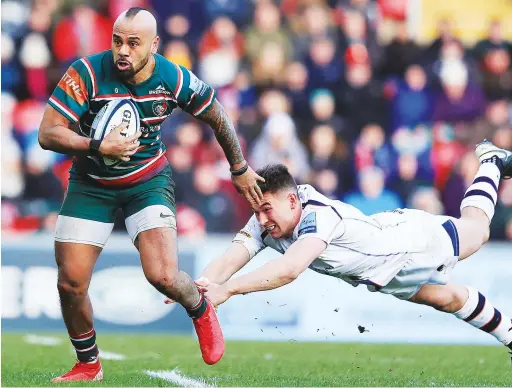  ?? PICTURES: Getty Images ?? Away: Tigers’ Telusa Veainu breaks through the tackle of Nick David