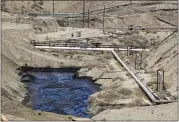  ?? IRFAN KHAN — LOS ANGELES TIMES VIA AP ?? A crew works on stopping seepage of 800,000gallons of oil from an abandoned Chevron well in McKittrick in July.