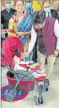  ?? HT PHOTO ?? UP civil aviation minister Nand Gopal Gupta ‘Nandi’ offers a piece of cake to a kid after the maiden flight from Indore lands at the Prayagraj airport.