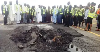  ??  ?? Minister of State, Aviation, Senator Hadi Sirika with his team of inspectors at a ruptured portion on the runway of Nnamdi Azikiwe Internatio­nal Airport Abuja yesterday. Pics: Chris Agabi.