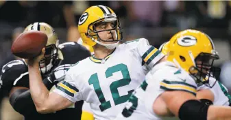  ?? Bill Haber / Associated Press 2014 ?? Packers quarterbac­k Aaron Rodgers, who also won the MVP in 2011, threw for 38 touchdowns and a league-low five intercepti­ons; he has thrown 512 passes at home without a pick.
