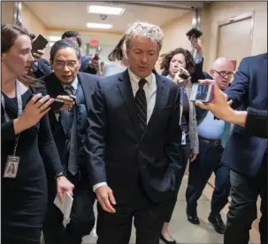  ?? The Associated Press ?? BUDGET BATTLE: Sen. Rand Paul, R-Ky., walks to the Senate floor Wednesday for a vote on Capitol Hill in Washington. As the Senate gets closer to another government funding deadline, Paul is protesting the pending $1.3 trillion spending bill, which he...