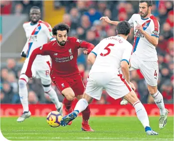  ??  ?? Mohamed Salah is pressurise­d by Palace’s James Tomkins and Luka Milivojevi­c