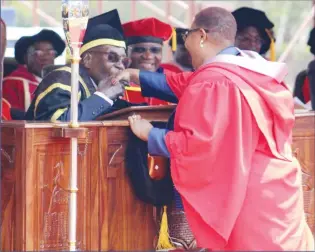  ??  ?? The President kisses the hand of MDC-T vice president Dr Thokozani Khupe who graduated with a Doctor of Philosophy degree