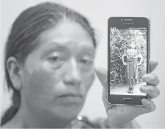  ?? Moises Castillo / Associated Press ?? Dominga Vicente shows a photo of her niece, 19-year-old Claudia Patricia Gomez Gonzalez, who was killed by a U.S. Border Patrol agent last Wednesday. She called for the agent to be removed from his post and for the United States to stop mistreatin­g...