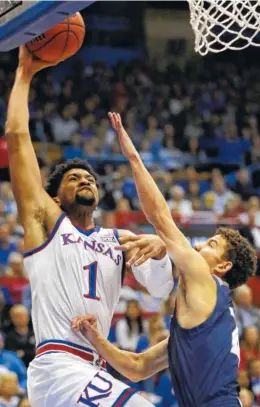  ?? AP PHOTO/ORLIN WAGNER ?? Kansas forward Dedric Lawson drives against Washburn forward Will McKee during an exhibition game Thursday in Lawrence, Kan.