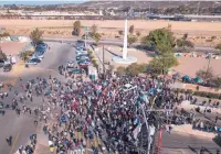  ?? THE ASSOCIATED PRESS ?? A group of migrants gathered at the border crossing at Tijuana, Mexico, Nov. 25 and tried to pressure its way into the United States.