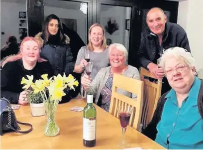  ??  ?? ●»Wendy Cheetham shares a bottle of wine with people she rescued from the M62