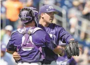  ?? Nati Harnik / Associated Press ?? TCU pitcher Sean Wymer (right) and catcher Evan Skoug hug after Louisville’s final out.