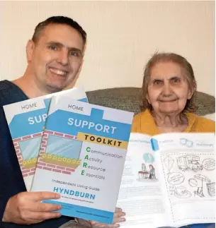  ?? ?? Neil and his mother, Jacqueline, holding Home Support Booklets that are being distribute­d to Hyndburn GP practices