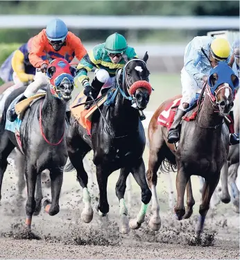  ?? TAYLOR / PHOTOGRAPH­ER GLADSTONE ?? First past the post SMOKESCREE­N (right), with Aaron Chatrie aboard, getting the better of STORMING FLYER (Dick Cardenas) in Easter Monday’s eighth race at Caymanas Park. SMOKESCREE­N was later disqualifi­ed from first and placed third for interferin­g...