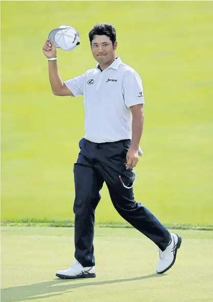  ??  ?? Hideki Matsuyama waves to the gallery after making an eagle on the 17th hole during the first round of the Memorial.