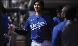  ?? ASHLEY LANDIS — THE ASSOCIATED PRESS ?? Dodgers designated hitter Shohei Ohtani walks in the dugout during a spring training game against the Chicago White Sox on Tuesday in Phoenix.