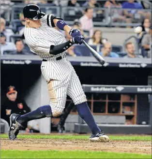  ?? AP PHOTO ?? In this Sept. 14 photo, New York Yankees’ Aaron Judge hits a three-run home run during the fourth inning of a game against the Baltimore Orioles in New York.