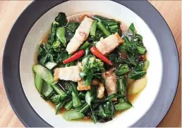  ??  ?? The stir-fried kailan with crispy pork belly offers a delicious juxtaposit­ion of crunchy vegetables offset by tender pork pieces.