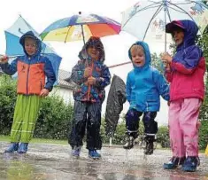  ??  ?? Machen das Beste aus dem Dauerregen: Elias, Anna, Tom und Elias (von links) haben in Erfurt Spaß daran, in die Pfützen zu springen. Foto: Marco Schmidt