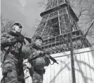  ?? BENOIT TESSIER/REUTERS ?? French soldiers patrol at the Eiffel Tower on Monday in Paris. France raised its terror alert to its highest level following Friday’s shooting in Moscow.