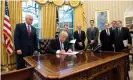  ?? Photograph: Ron Sachs / Pool/EPA ?? Donald Trump, watched by Mike Pence, among others, signs the ‘global gag rule’ in 2017.