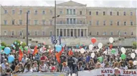  ?? — AFP ?? ATHENS: Employees from the municipal kindergard­ens protest outside the Greek parliament in Athens yesterday during their 48-hour strike. The Greek parliament adopted a new round of austerity cuts which the government hopes will secure a pledge of debt...
