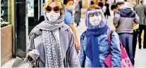  ?? (AFP) ?? Shoppers wearing face masks, shields and latex gloves in the Tajrish Bazaar in Iran’s capital Tehran