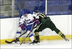  ?? JULIA MALAKIE / LOWELL SUN ?? Umass Lowell's chase Blackmun and Vermont's Jacques Bouquot battle for the puck during a hockey East tournament game.