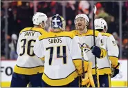  ?? DERIK HAMILTON — THE ASSOCIATED PRESS ?? Nashville Predators goaltender Juuse Saros (74) and Matt Duchene, second from right, celebrate after a win in overtime of an NHL hockey game against the Philadelph­ia Flyers on Saturday in Philadelph­ia.