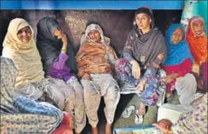  ?? RAJ K RAJ/HT PHOTOS ?? Junaid's mother Saira (centre) mourns at her house in Ballabhgar­h on Monday. In Junaid’s house, the hearth (right) stands cold on the day of Eid.