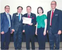  ??  ?? Chan (third from left) was handed the Paul Harris Fellow Award for his innumerabl­e contributi­ons to REF.