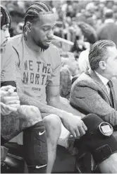  ?? NATHAN DENETTE/AP ?? Raptors forward Kawhi Leonard puts a heating wrap on his knee during Game 3, in which he played 52 minutes.