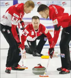  ?? Associated Press photo ?? Canada skip Brad Gushue, centre, delivers a stone against Sweden during the World Men's Curling Championsh­ip Friday in Las Vegas.