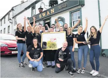  ??  ?? Cheers! Swan Inn staff celebrate their Sunday Mail Pub of the Year success