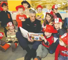  ?? FILES ?? Calgary fire Chief Steve Dongworth reads to kids in January, 2019, as part of a partnershi­p with Calgary Public Library to support early learning and literacy. Library programs like this are supported by fundraisin­g.