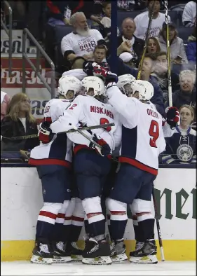  ?? AP PHOTO ?? Members of the Washington Capitals celebrate a goal against Columbus on Monday.