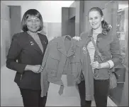 ?? U.S. Air Force/airman 1st Class Jennifer Zima ?? U.S. Army retired Col. Edna Cummings, “The Six Triple Eight” documentar­y film producer, and Sophie Green, a guest, hold a 6888th Central Postal Directory Battalion uniform belonging to Pvt. Grace Vairin. The jacket is on loan to the 6th Cavalry Museum for the exhibit.